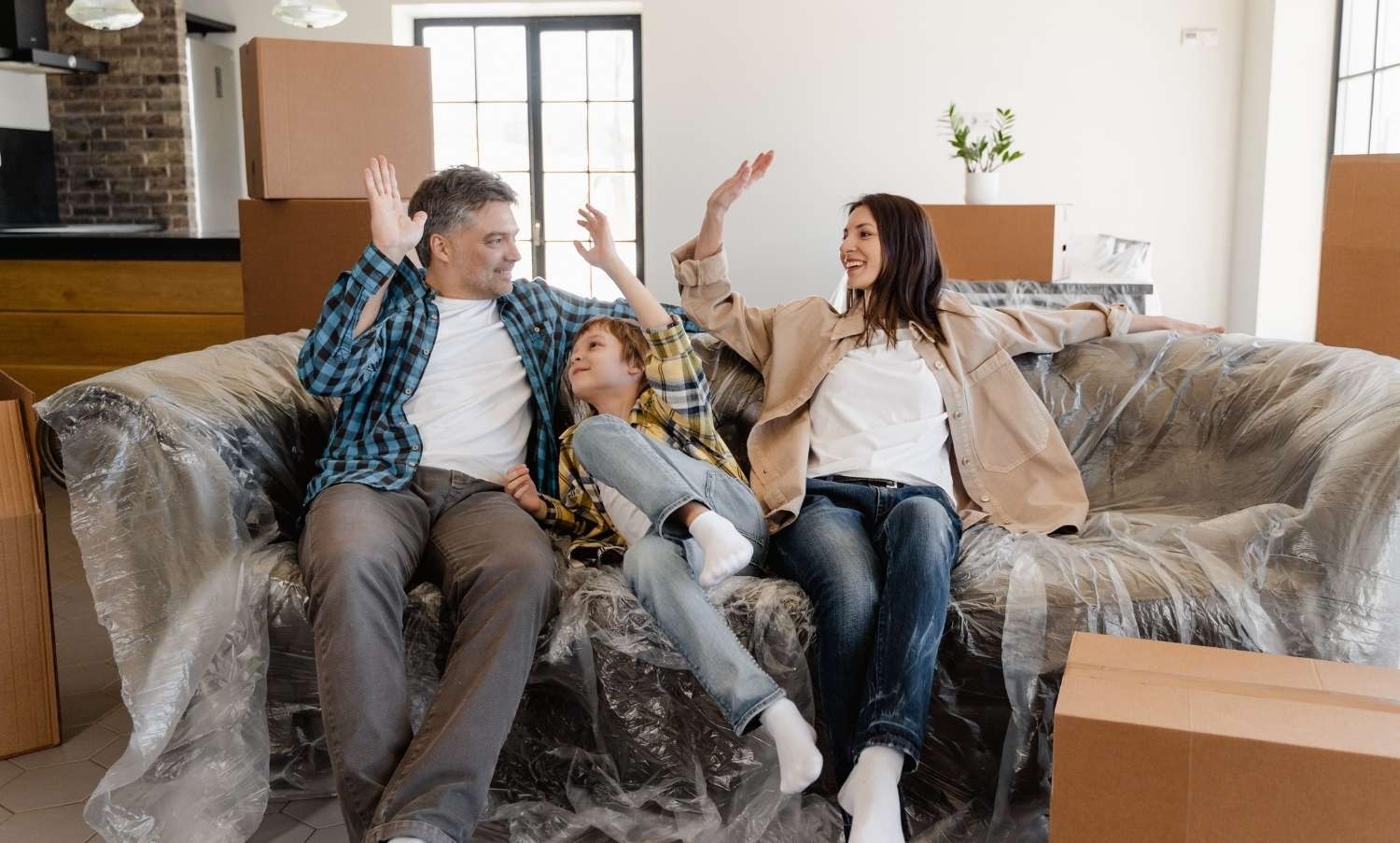 Family packing their belongings after selling their home in Huntington Beach with The Malakai Sparks Group.