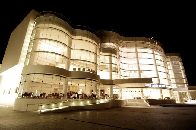 costa-mesa-cover-1 Costa Mesa Segerstrom Concert Hall at night, Orange County arts landmark for homebuyers comparing Costa Mesa and Huntington Beach.