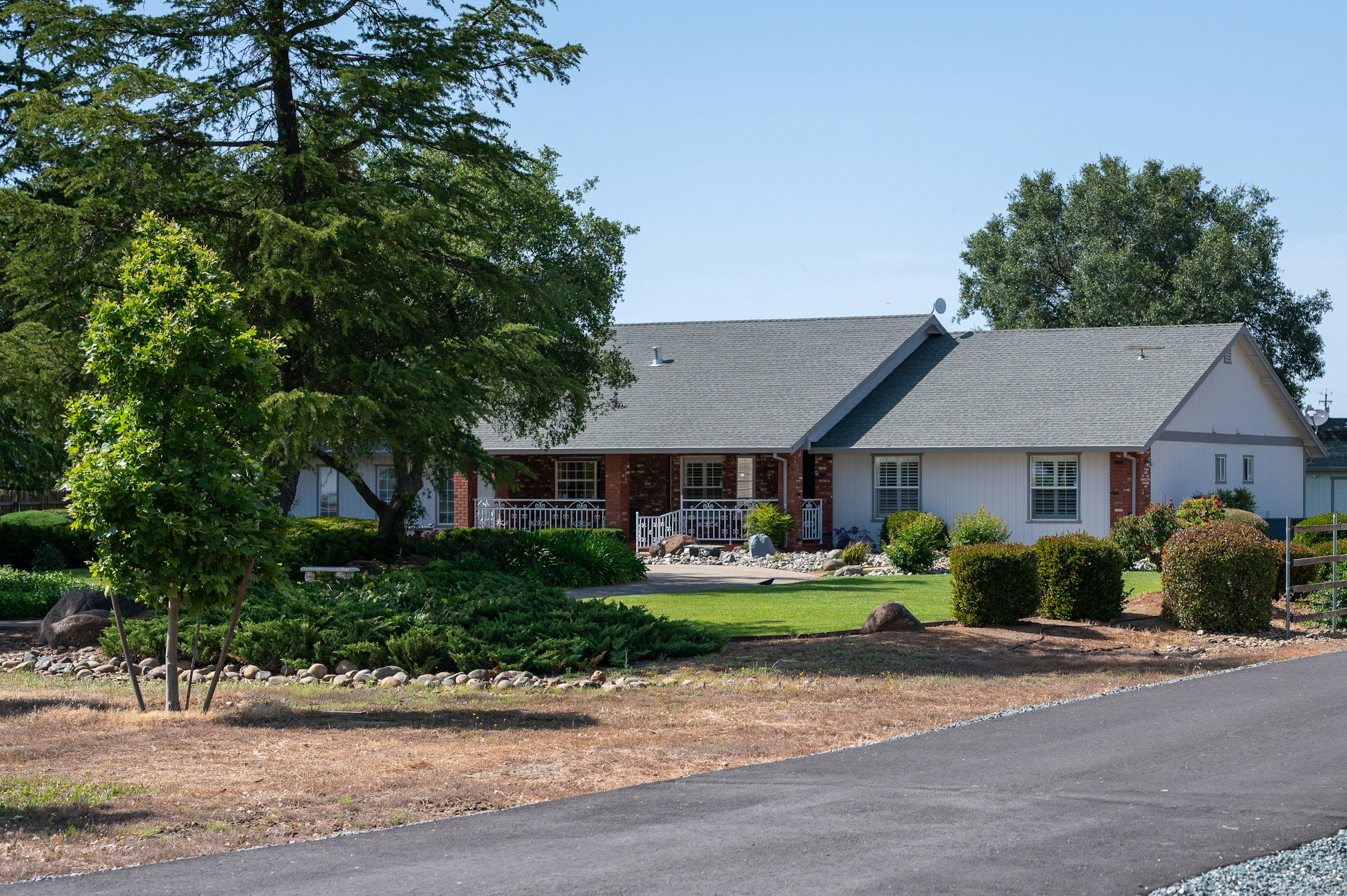 California single-family tract home with front lawn on a quiet inland Huntington Beach residential street