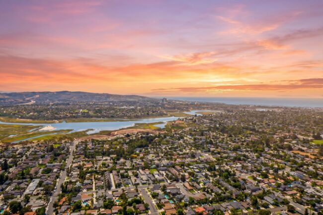 eastside-costa-mesa-aerial-sunset.jpg Aerial view of Eastside Costa Mesa homes at sunset, with the Back Bay and the ocean behind